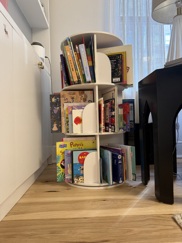 Rotating bookcase filled with children's books, offering space-saving storage solutions. Ideal for kids' rooms or small spaces in New York, NY.
