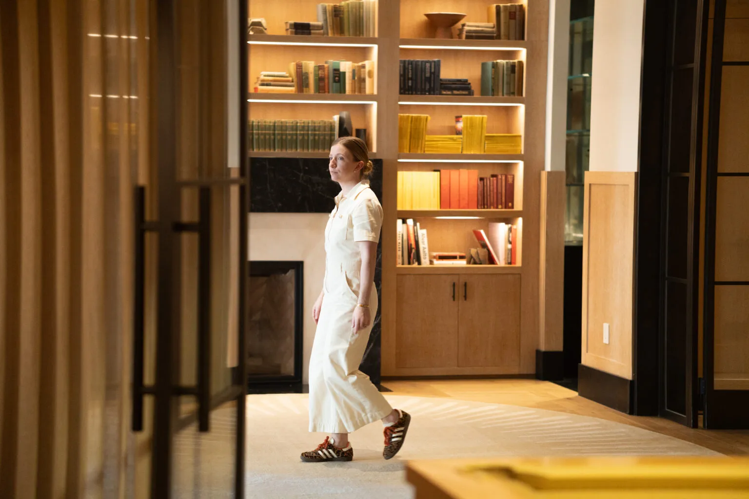 An ORG NYC organizer walking through a New York apartment between rooms