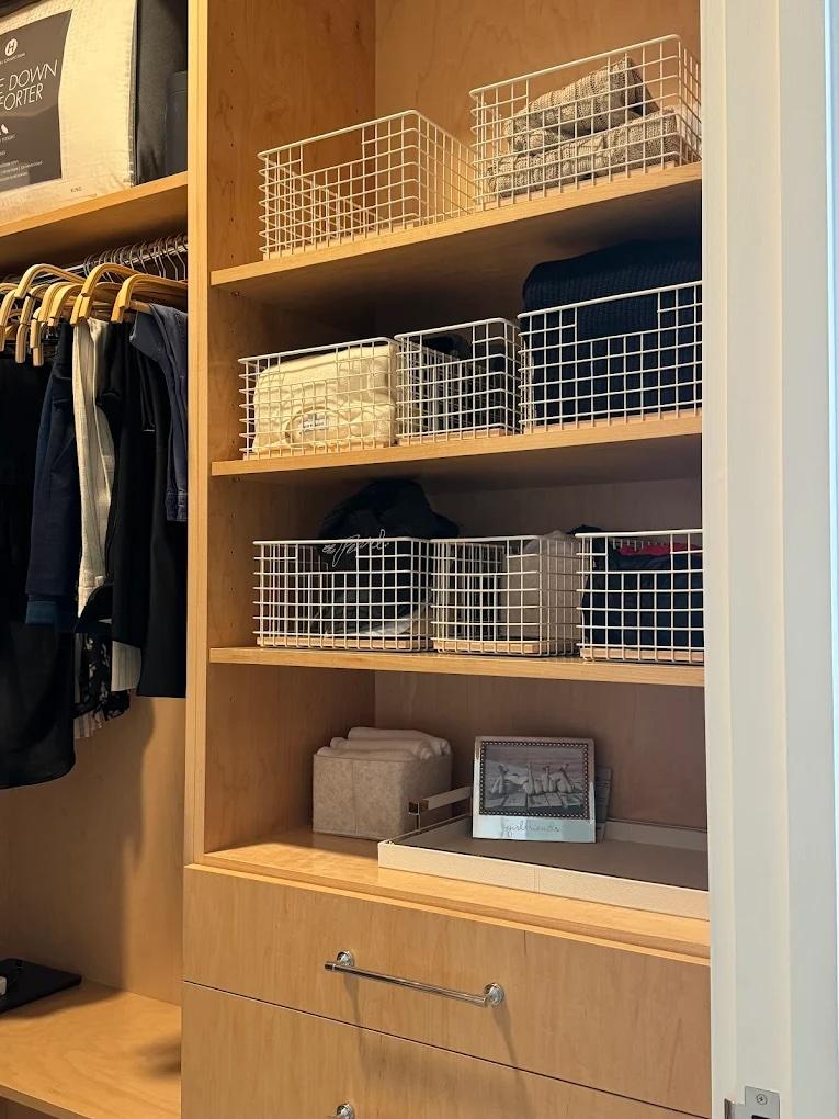 Organized closet with wire baskets: a solution to the hidden cost of clutter in NYC homes, saving time, reducing stress, and maximizing space.