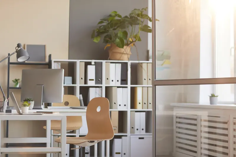 Organized office space with desk, computer, and shelving, promoting productivity and focus in New York