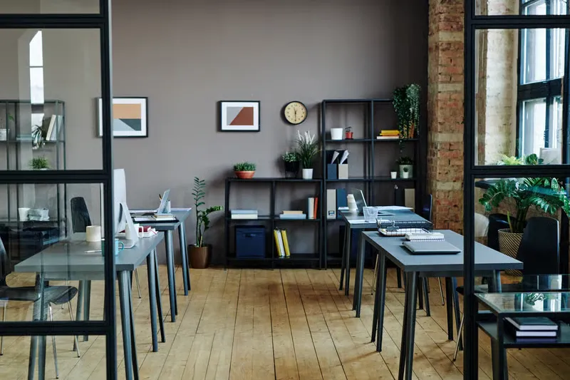 Shared office storage shelves and desk workstations in a modern space that requires organization for various team members